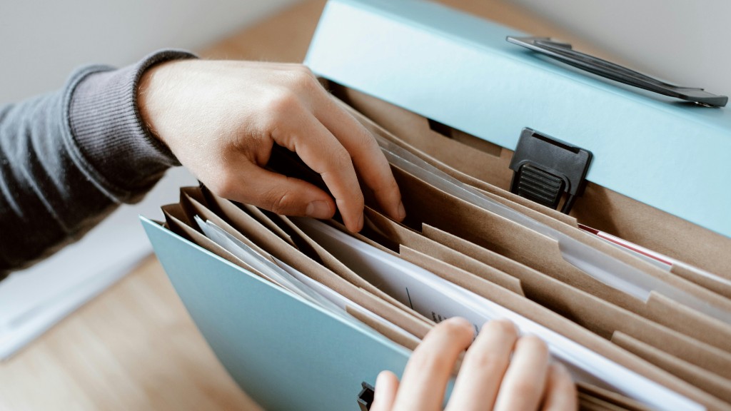 Hands searching for documents in a folder